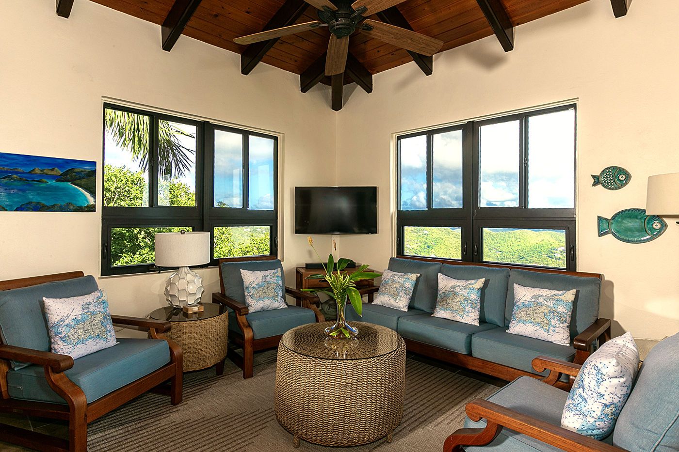 Villa living room under a vaulted tropical-hardwood ceiling